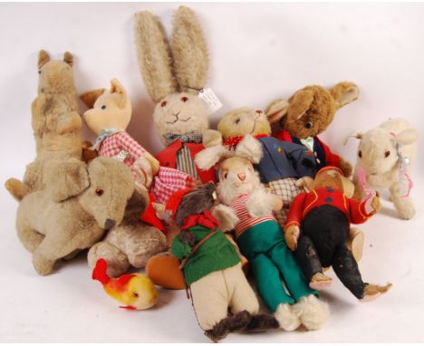 A collection of assorted vintage stuffed toys teddy bear animals to include Deans Rag Book 1930's bunny, monkey in bellhop at