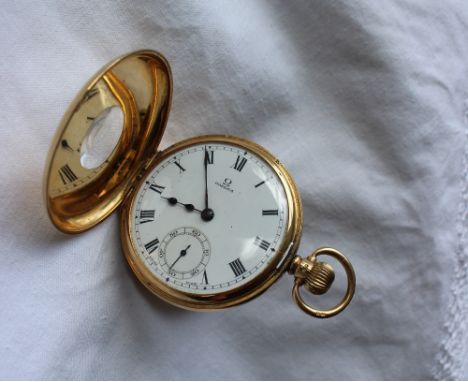 An 18ct yellow gold Omega keyless wound half hunter pocket watch, with an enamel dial, Roman numerals and a seconds subsidiar