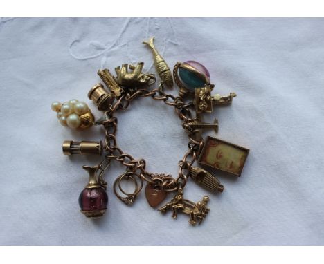 A 9ct yellow gold charm bracelet set with numerous charms including figures on a bench, speed boat, aeroplane, baby on a scal