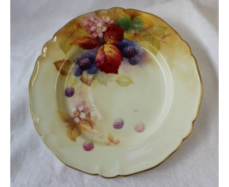 A Royal Worcester porcelain plate painted with blackberries and leaves to an ivory ground, signed by Kitty Blake, puce mark a