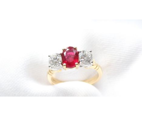 A ruby and diamond ring, the central oval mixed cut strong red transparent natural ruby 7.55mm x 5.57mm x 2.91mm measuring 1.