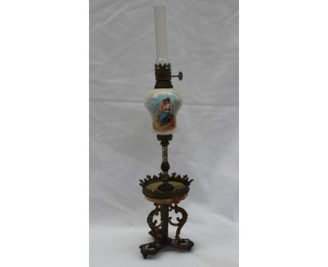 A miniature champleve enamel decorated oil lamp, the pottery reservoir painted with a spray of garden flowers with an onyx sh