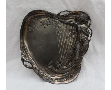 An electroplated WMF dish of heart shape, cast with a maiden in diaphanous dress leaning on a harp, 23cm high x 21.5cm wide
