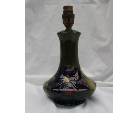 A Moorcroft pottery table lamp decorated in the clematis pattern, to a green ground, 19cm high 