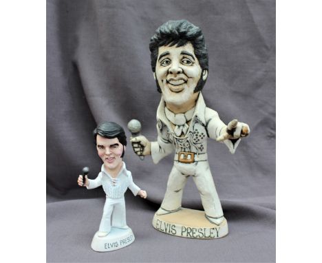 A John Hughes pottery Grogg of Elvis Presley, in white suit holding a microphone, signed to the base, 29.5cm high together wi