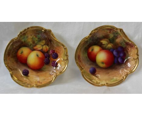A pair of Royal Worcester porcelain lobed dishes painted with apples, grapes and blackberries to a naturalistic ground signed