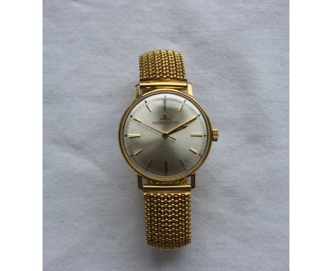 A Jaeger-LeCoultre Gentleman's wristwatch, with a champagne dial and batons, the reverse inscribed "25 years service B.P.C. K