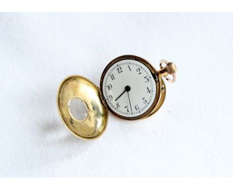 An 18ct yellow gold half hunter keyless wound fob watch, with a white enamel dial and Roman numerals, approximately 3cm diame