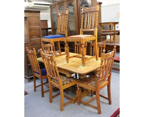 A Carved Oak Drawer Leaf Dining Table, first half 20th century, 152cm (open) by 90cm by 74cm, together with a similar set of 