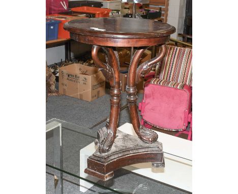A 19th Century Carved Mahogany Lamp Table, the moulded circular top supported by three swan head carved uprights, raised on a