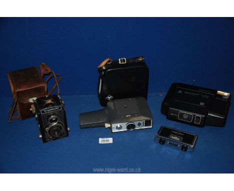 Three cameras including Kodamatic 980L Instant camera, a Voigtlander Brillant TLR camera in leather case, and an Agfa Moviex 