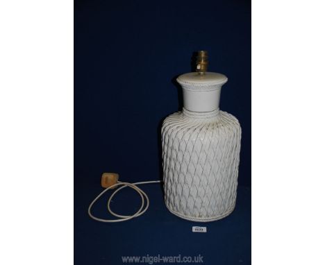 A decorative white ceramic Table Lamp with overlaid rope twist and lattice detail, 16" tall.