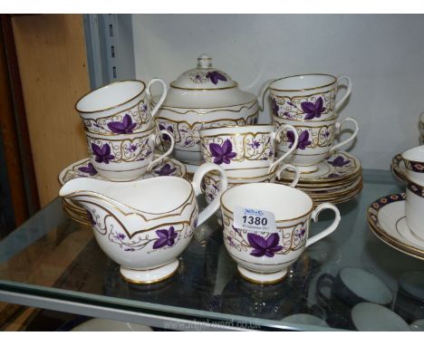 A Royal Worcester Teaset in purple and gold vine leaves and tendrils decoration to include seven cups, six saucers and tea pl