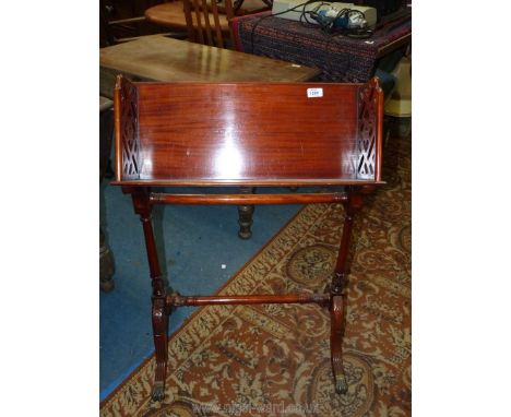 An attractive carved Book Trough on stand with arched legs and brass claw feet, 35'' tall.
