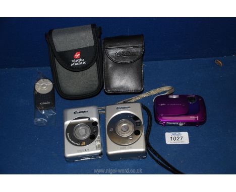 A Fujifilm Finepix 235 digital camera in purple together with a Canon IXUS Z50 digital camera with 26-52 mm Canon zoom lens f