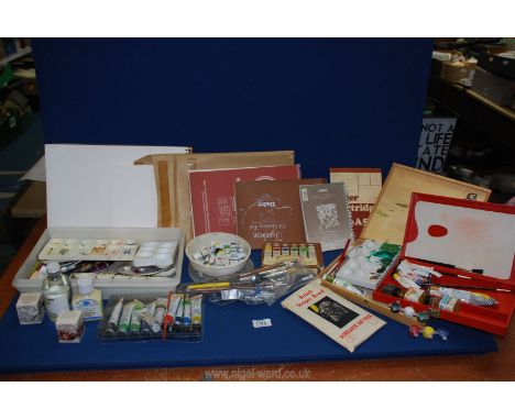 A quantity of artist's equipment including sketch pads, paint pallet, brushes, ink, watercolours, gouache, acrylics, some box
