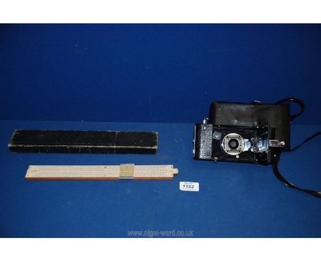 An old slide rule in case and 'The Myna' camera, with case.
