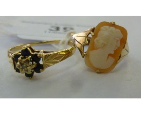 Two gold coloured metal rings, one claw set with sapphires; the other, a profile portrait cameo       11