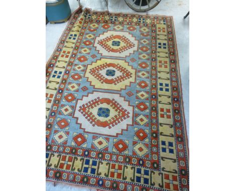 A Turkish carpet with geometric medallions on a pale blue ground  76'' x 114''       BSR