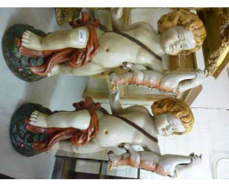 A pair of modern ceramic figures, each a standing cherub, holding a dead animal  26''h       BSR