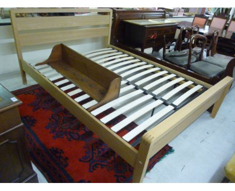 A modern light oak bed frame with a level, low, planked head and footboard and a slatted base  60''w       CS