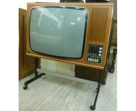 A ITT Consumer Products Ltd Aristocat 24'' television set in a teak finished case, the front console with five pre-set channe