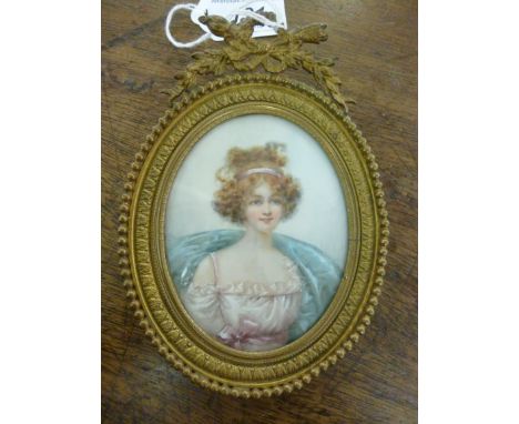 An early 20thC head and shoulders, oval portrait miniature, a young woman, her hair tied with a ribbon, wearing a pale pink d