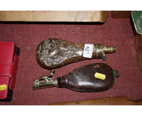 A brass and leather powder flask together with a brass embossed powder flask decorated with a hunting scene AF