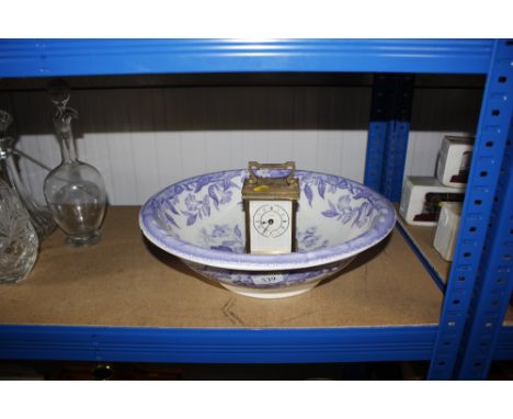 A wash bowl and mantel clock