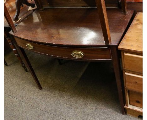 A George III mahogany bowfront writing table, with single frieze drawer on square tapering legs, together with a similar exam