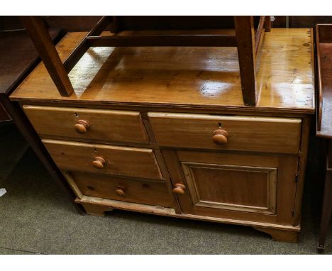 A Victorian pine enclosed dresser with four drawers above a cupboard door, on bracket