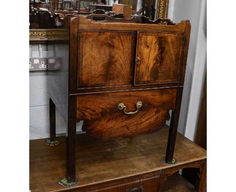 A George III mahogany washstand with hinged lid and cupboard door, on square legs joined by a cross stretcher, 48cm by 38cm b