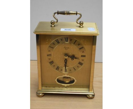 A brass 'Timemaster' mantel clock in German case.