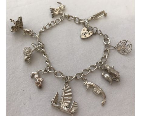 A ladies silver charm bracelet with padlock and safety chain and 9 charms.  Total weight approx. 28g.