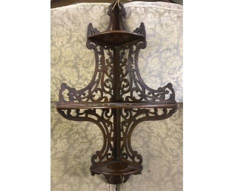 A vintage 3 tier corner shelf with ornate fretwork sides.  Approx. 82cm tall.