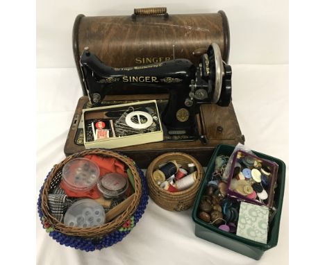 Cased singer sewing machine with vintage sewing accessories. To include button, buckles needles and cotton threads. 