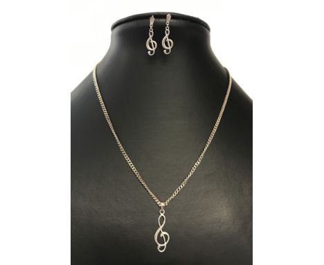 A silver pendant chain and earrings set with 'treble clef' design. Approx 16" chain. 