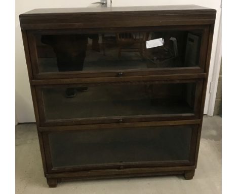 A vintage Globe Wernicke style 3 tier bookcase. With glass fronted lift up doors. Approx. 90cm wide x 100cm tall.