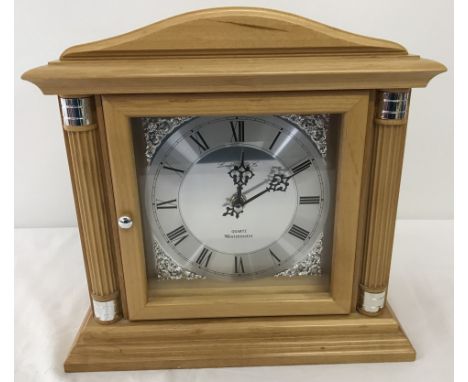 A modern Quartz Westminster chime wooden cased mantle clock. in light wood case, working order. 