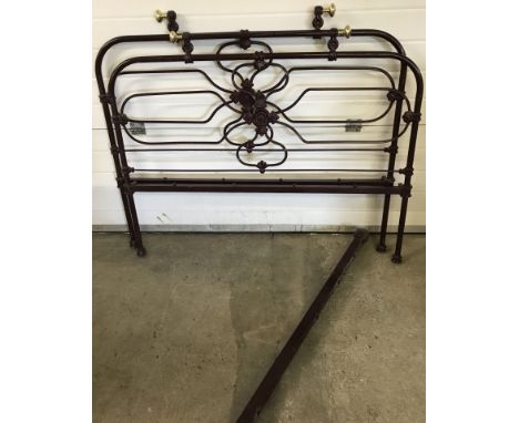 A vintage burgundy painted and brass single bed frame.  