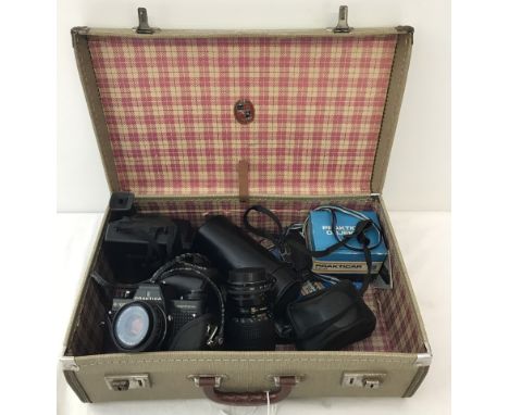 A vintage pioneer luggage small suitcase containing cameras and lenses. To include a Polaroid camera, A Praktica B100 electro