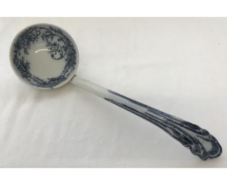 A Victorian ceramic ladle with flo blue decoration to bowl and handle.  
