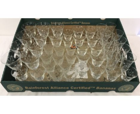 A box containing a quantity of matching glasses sets with transfer print floral design. Together with 10 port / claret glasse