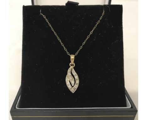 A 9ct gold pendant set with approx 10 small diamonds. On a fine chain. 