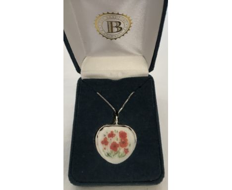 A boxed Bradford Exchange crystal heart shaped pendant with poppy decoration on 925 silver chain.  Chain 18".
