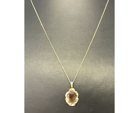 A hallmarked 9ct gold pendant set with oval Smoked Quartz on a very fine 9ct gold chain.  Chain length 18".