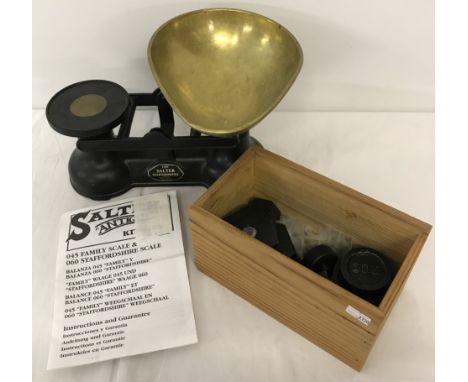 A modern set of Salter kitchen scales together with a quantity of weights.  