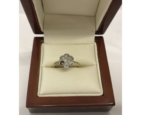 Vintage 18ct gold ring set with 6 diamonds in a flower design. Has one diamond missing. Total weight approx 2.3g.