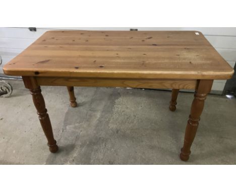 A vintage pine kitchen table with turned legs. Some marks on top. Approx. 122cm x 68cm.