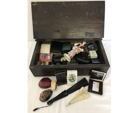 A vintage wooden box  with lift up lid full of mixed items. To include vintage playing cards, fans, hunting knife, paperweigh